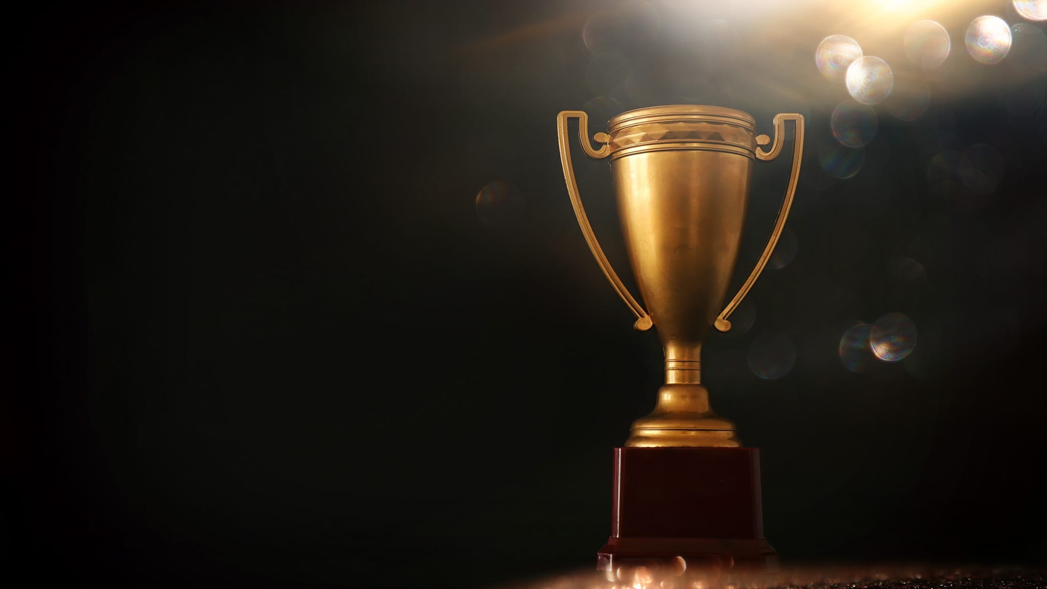 Trophy award sitting against black background