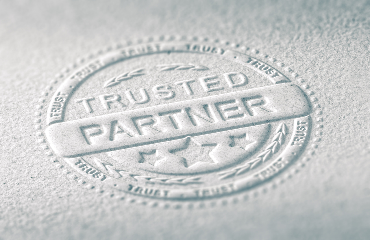Trusted Partner embossed on a piece of paper