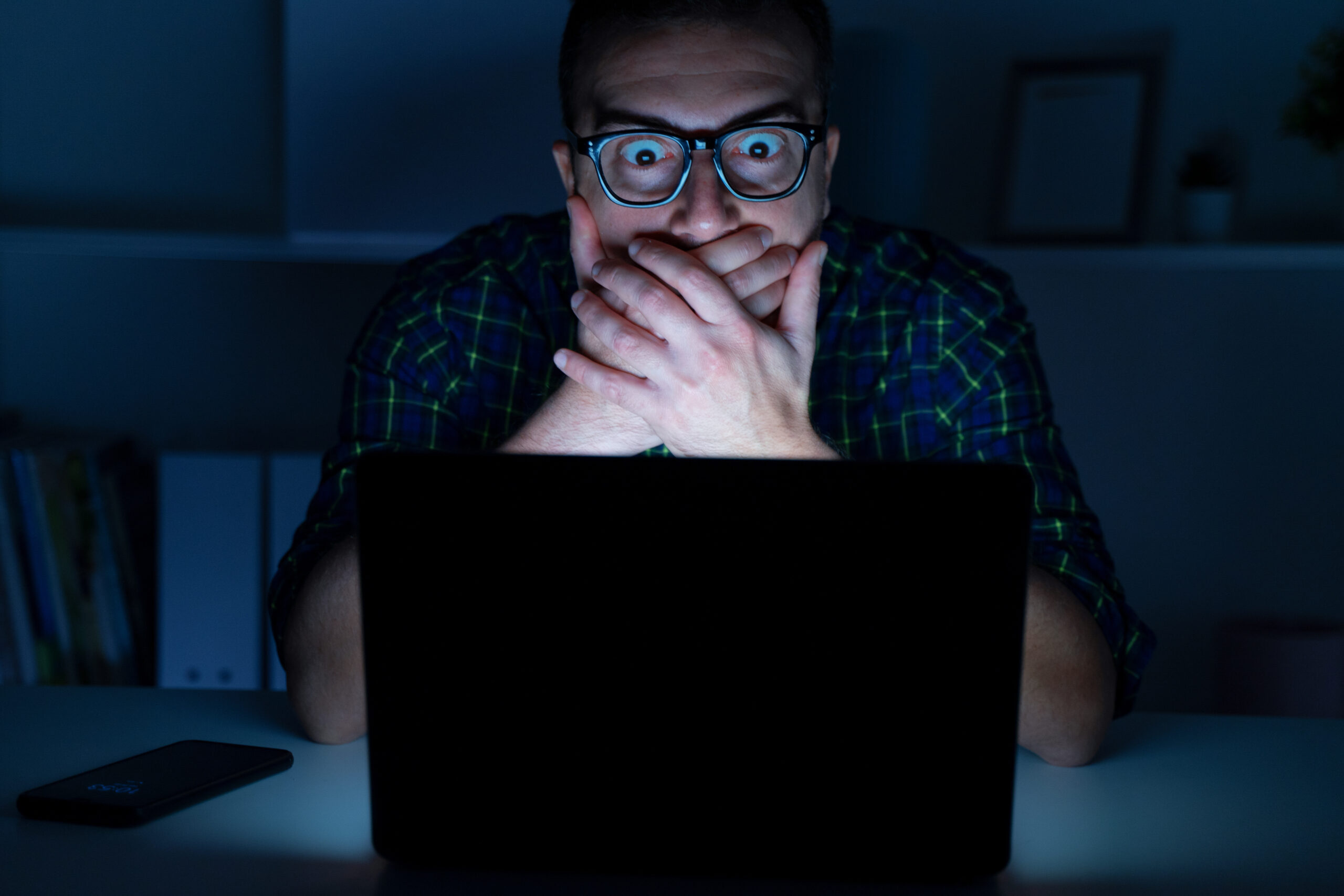 Portrait of shocked man on a laptop