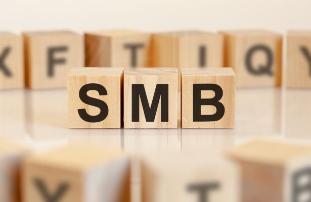 three wooden cubes are on a table displaying the letters SMB