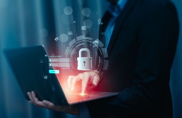 man holding a open laptop with superimposed image of a padlock and a login screen