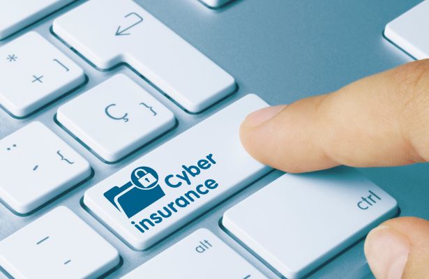 human tapping a 'cyber insurance' key on a keyboard