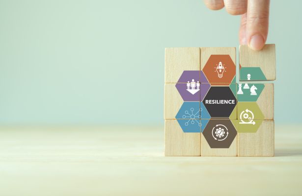 wooden blocks with multi coloured hexagons with various tech icons and the word resilience