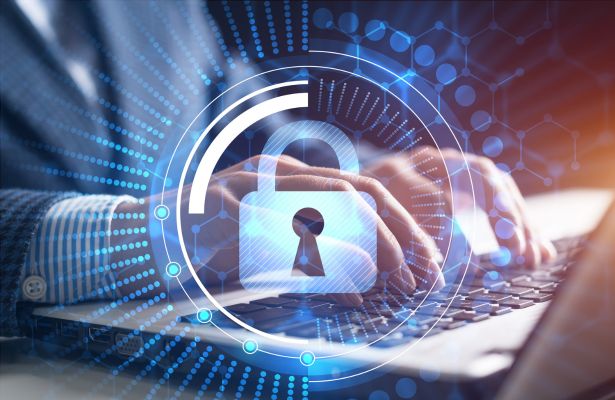 man using a laptop with a digital padlock and hexagonal pattern superimposed
