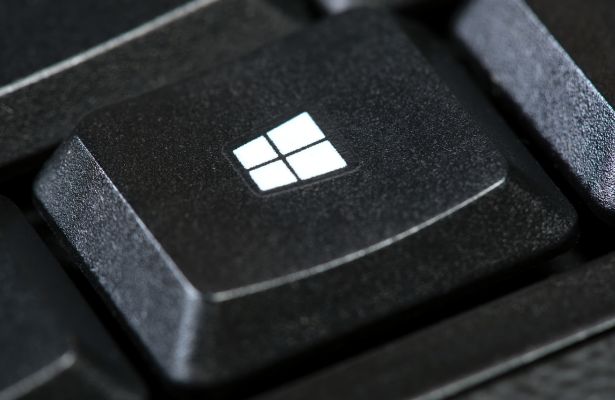 close up of windows logo on a simple black desktop PC computer keyboard