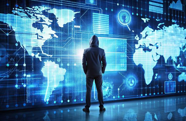silhouette of person in front of large digital screen displaying a map of the world with dialog boxes showing cyber threats and vulnerabilities