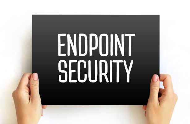 human holding a black sign with white text that says Endpoint Security in the centre.