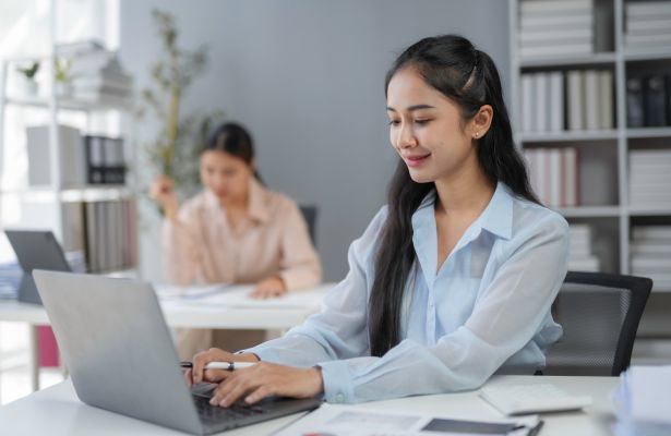 Two business women working on their laptops